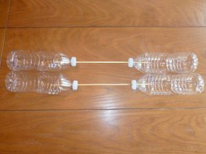 four bottles with two sticks