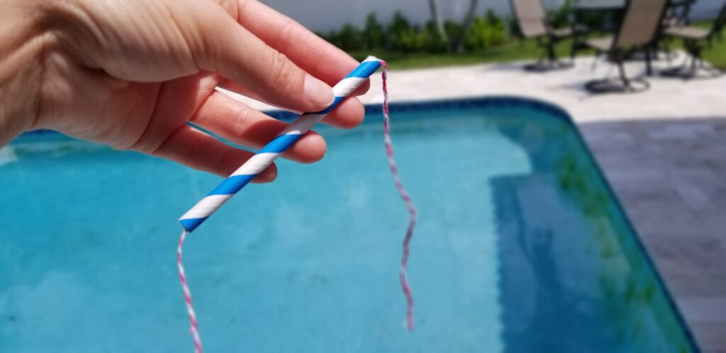 place cut string through the straw