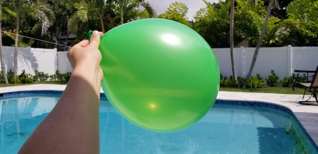 hand holding balloon filled with air