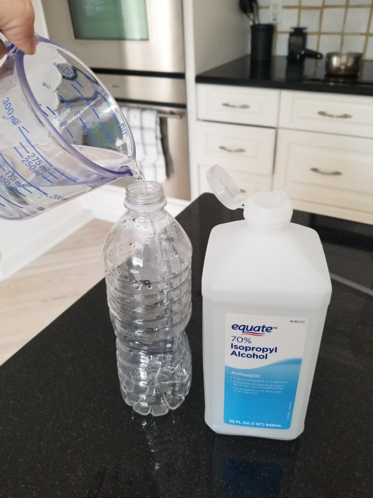 pouring rubbing alcohol into plastic bottle