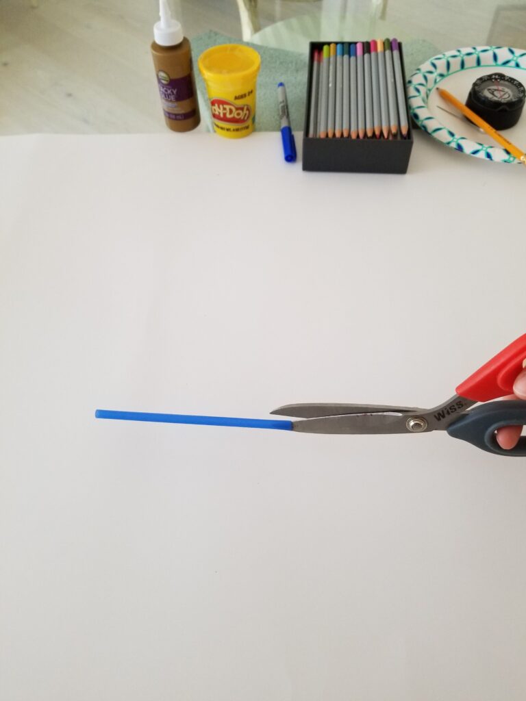 use scissors to cut slits at ends of straw
