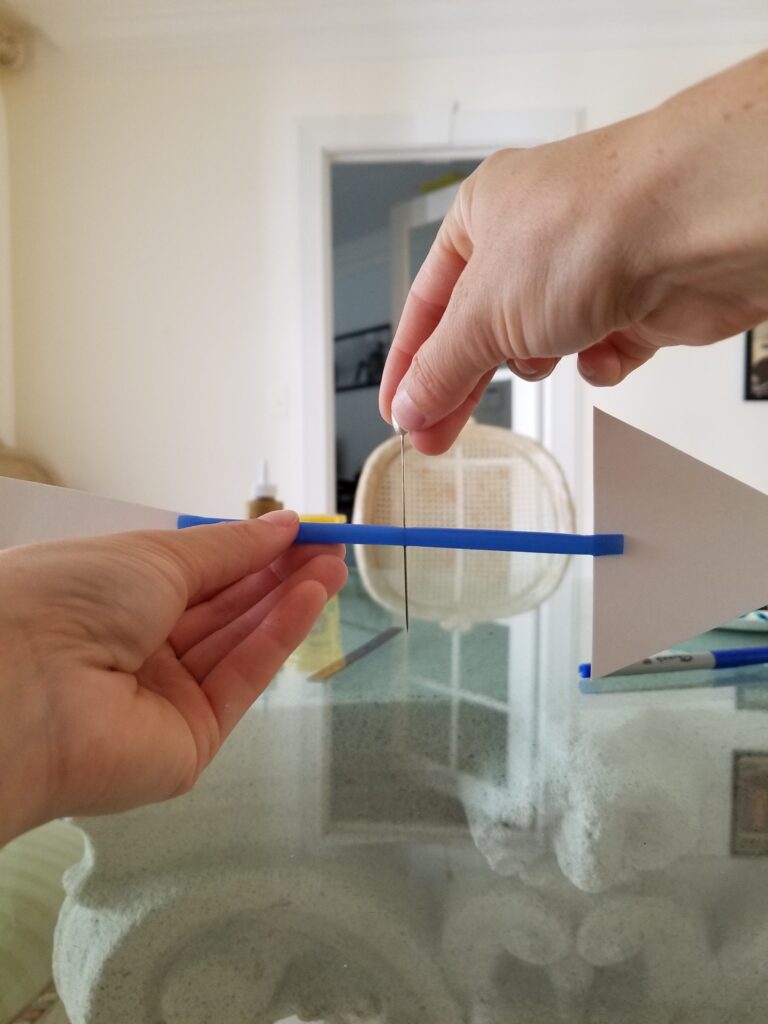 stick the straight pin in center of plastic straw