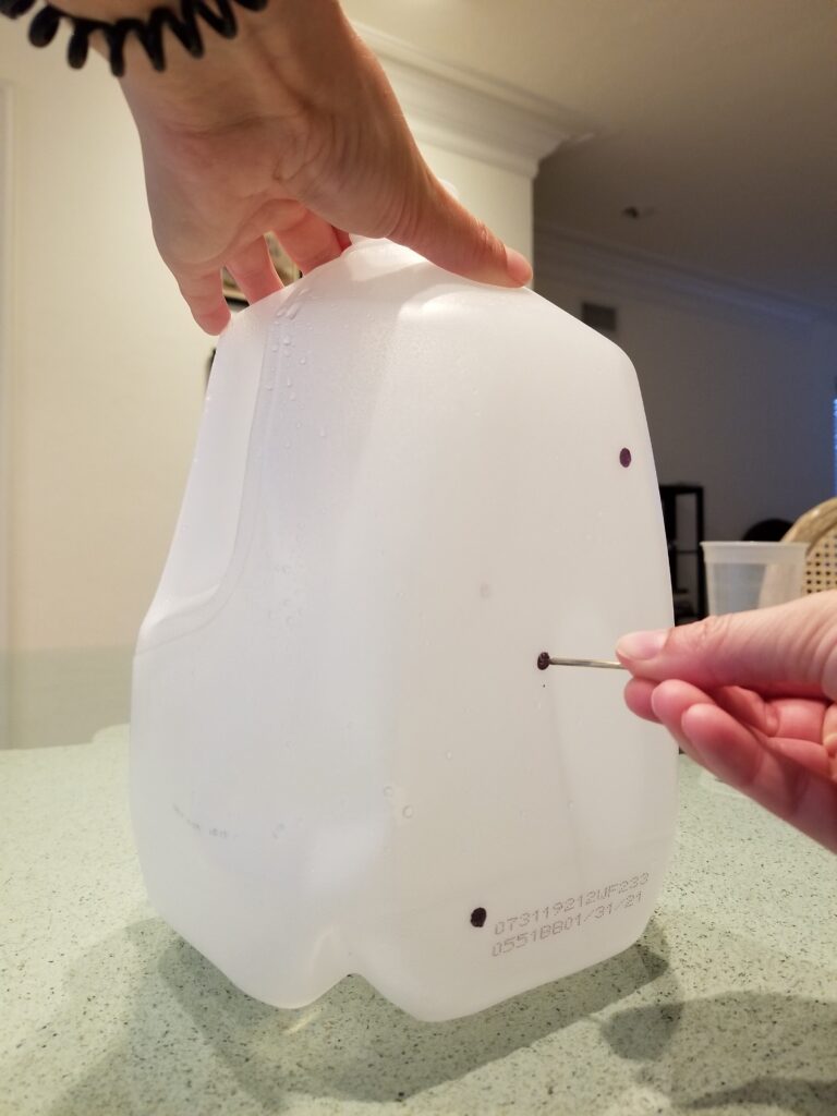 poking holes in empty milk jug