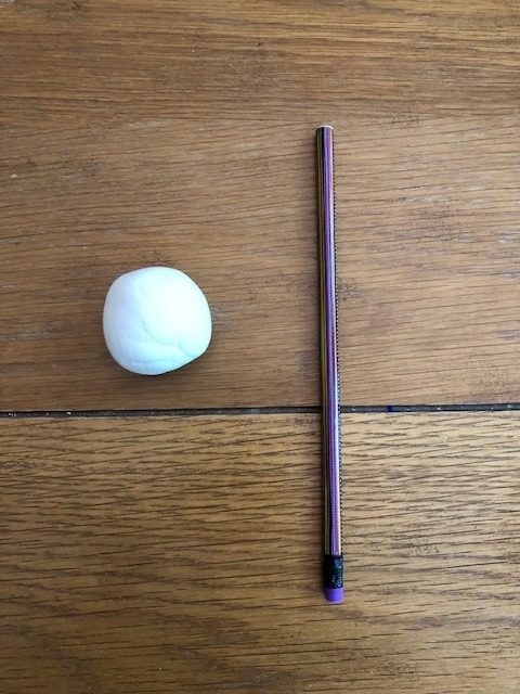 pencil next to a white ball of modeling clay