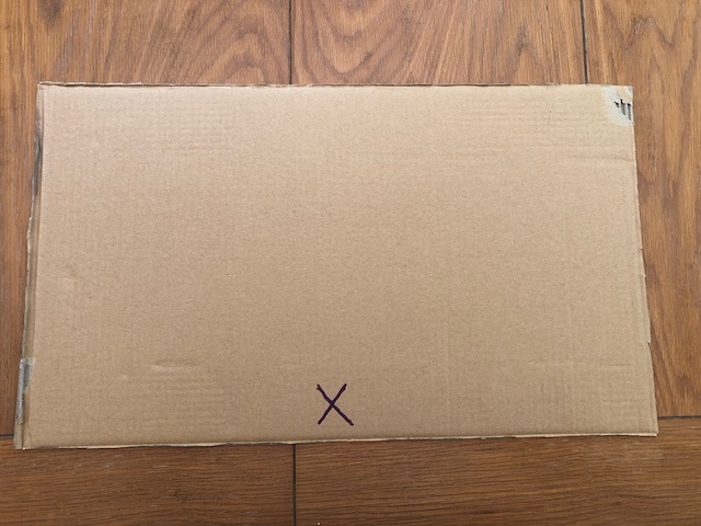 rectangle of cardboard with x on the bottom