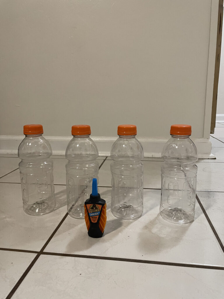 four clear bottles and glue