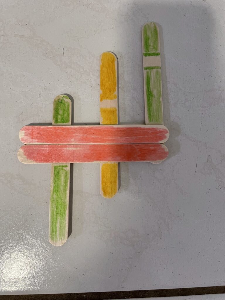 Colored popsicle sticks glued on top of another