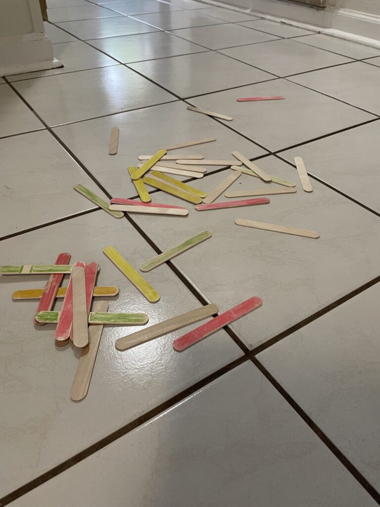 Pile of popsicle sticks on the floor