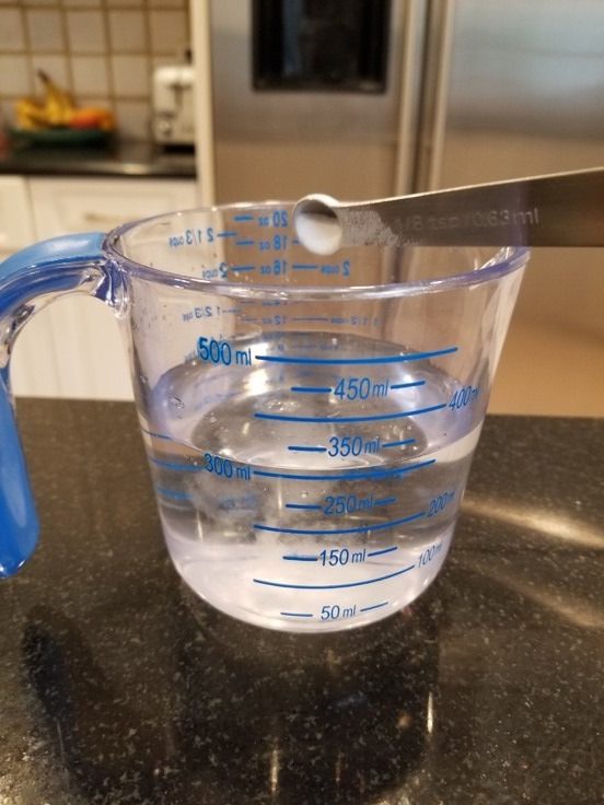 measuring glass with water