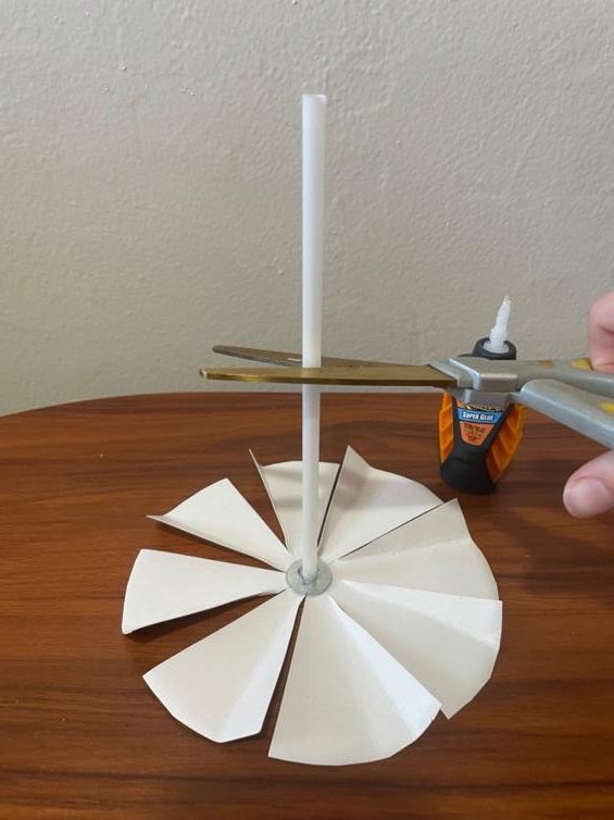 paper carousel with straw being cut