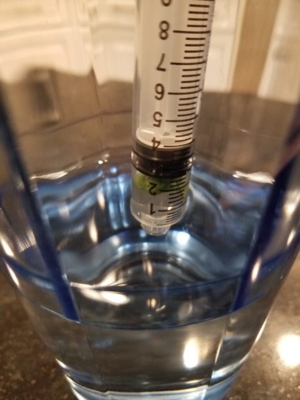 syringe dipped in water solution