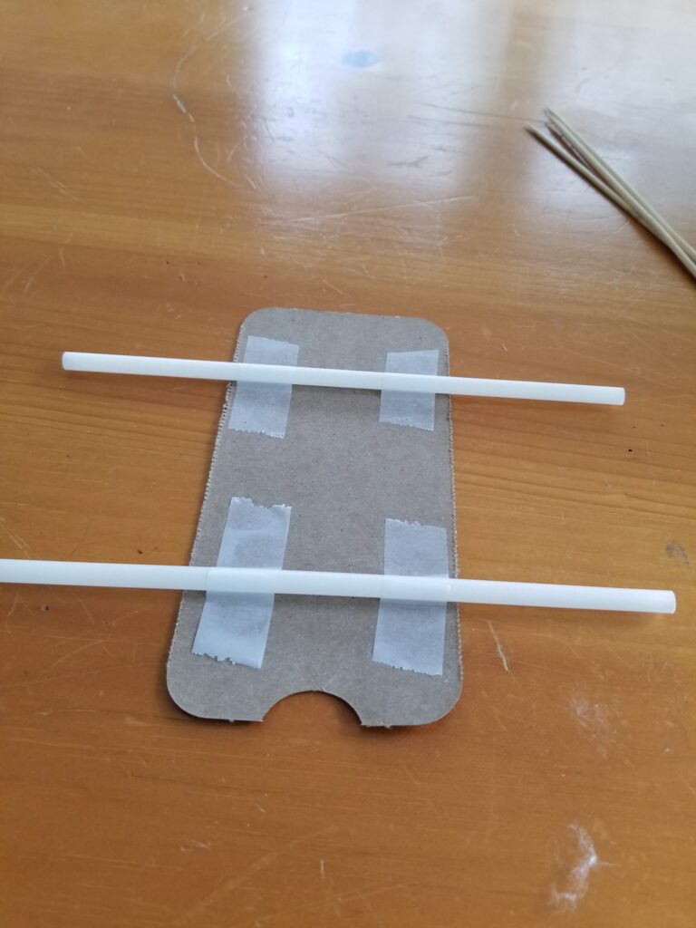 two straws taped to cardboard