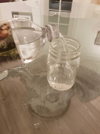 water poured into glass jar
